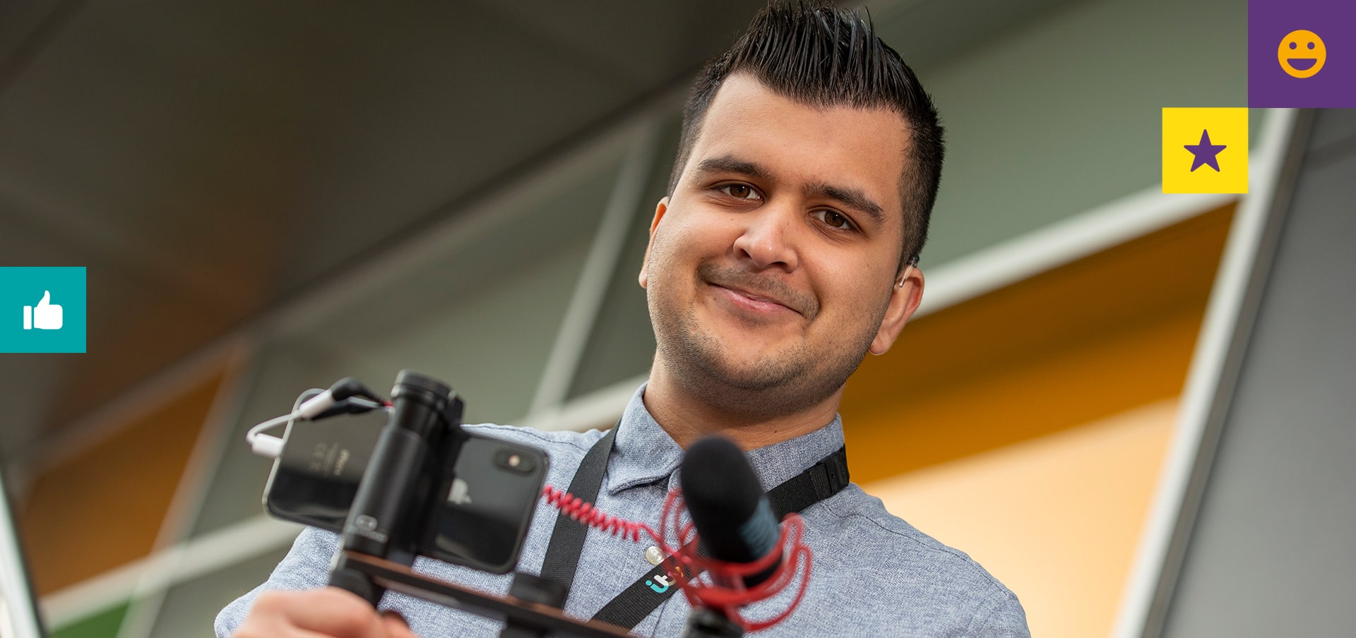 Creative apprentice Safyan holding a camera