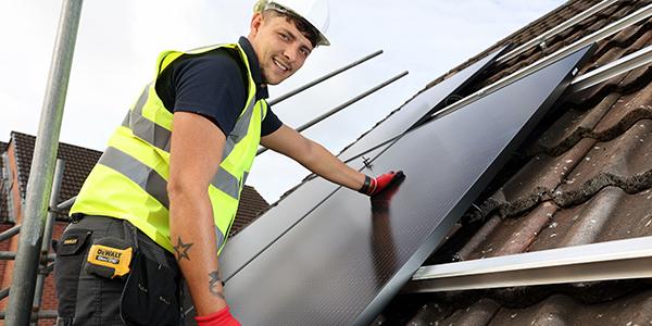 Roofer installing solar panels